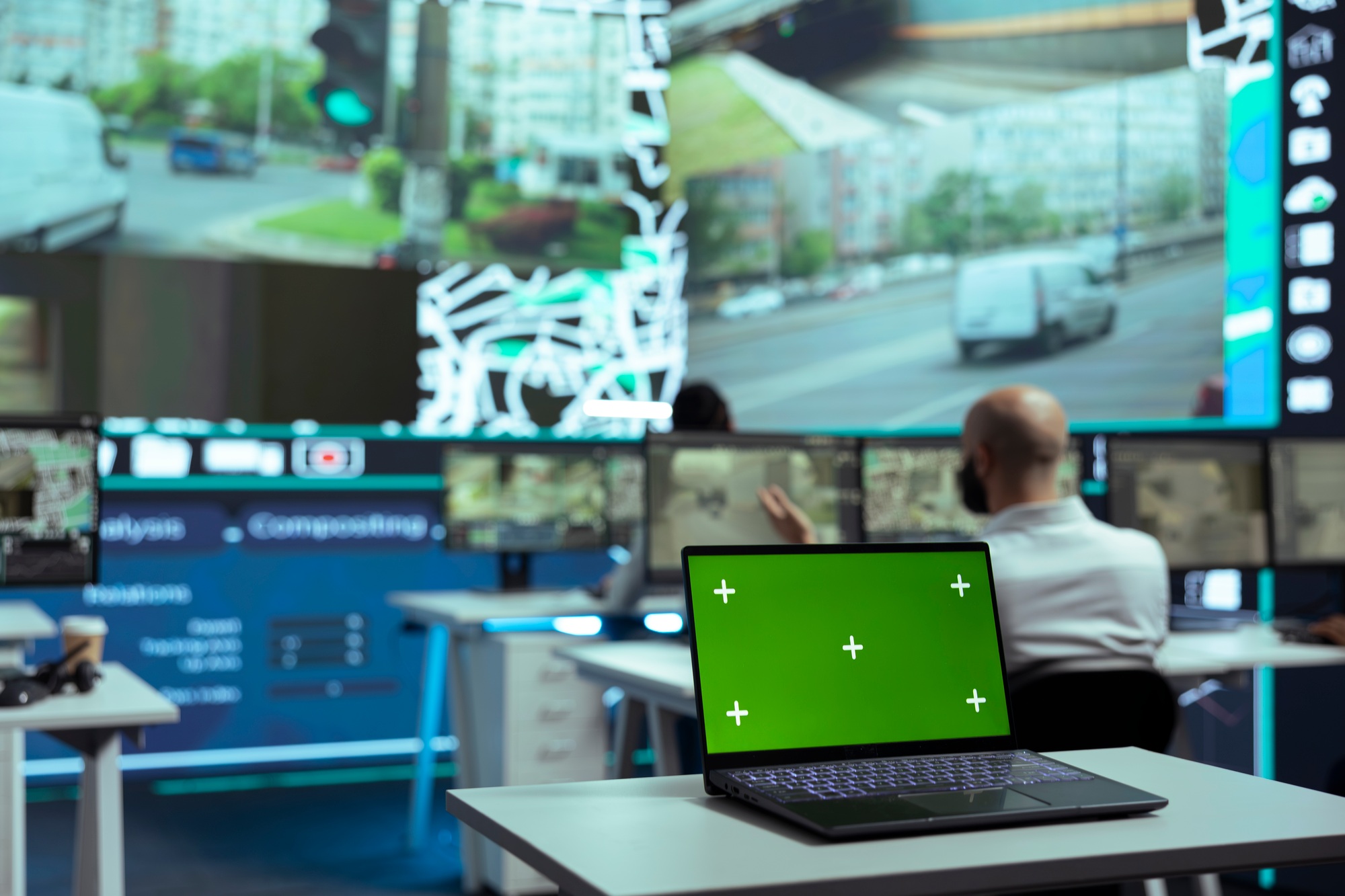 Diverse employees monitoring delivery trucks routes with an isolated screen
